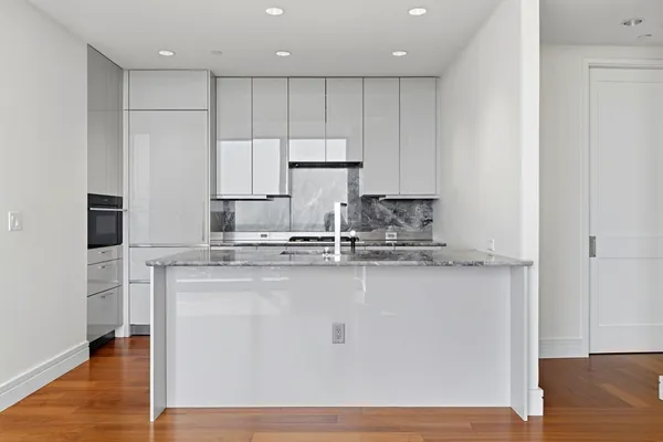 a kitchen with granite countertop cabinets stainless steel appliances and a sink