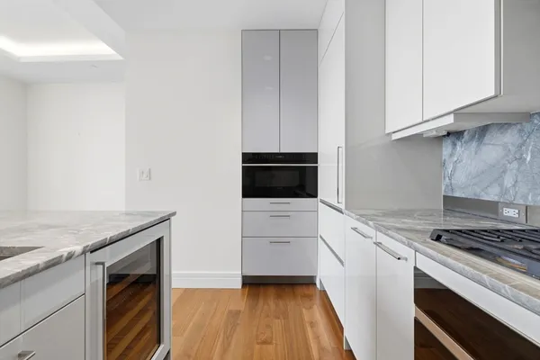 a kitchen with granite countertop a sink and cabinets
