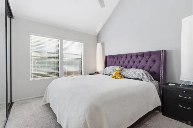 a bedroom with a large bed and a window