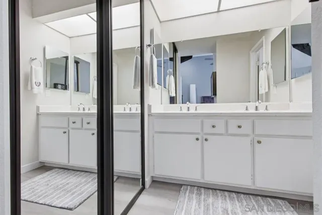 a bathroom with a toilet a sink and a mirror