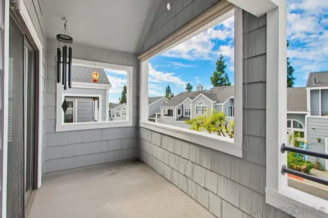a view of swimming pool with outdoor seating and trees in the background