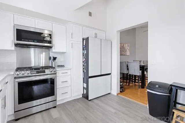 a kitchen with a stove a microwave and refrigerator
