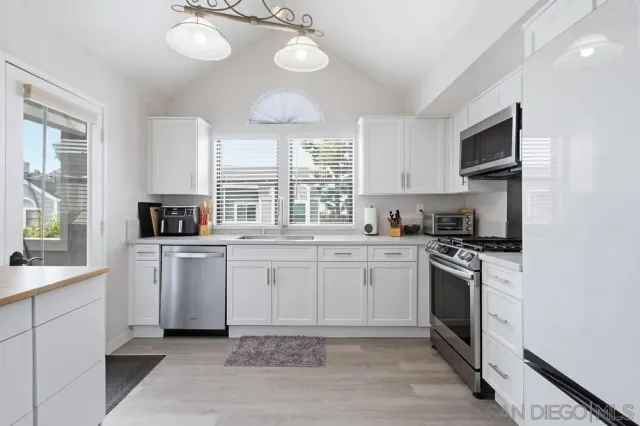 a kitchen with a sink stove and microwave