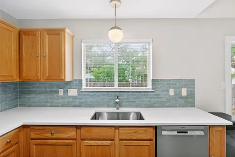 a kitchen with a sink and a window