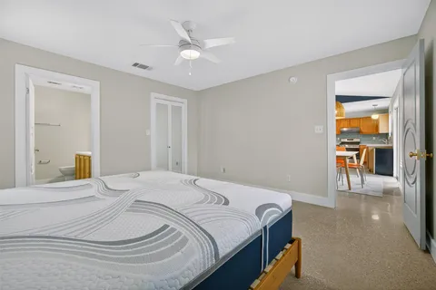 a bedroom with a bed and a chandelier