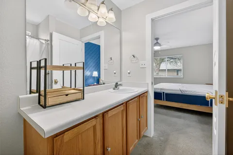 a en suite bathroom with a sink a large mirror and a bathtub