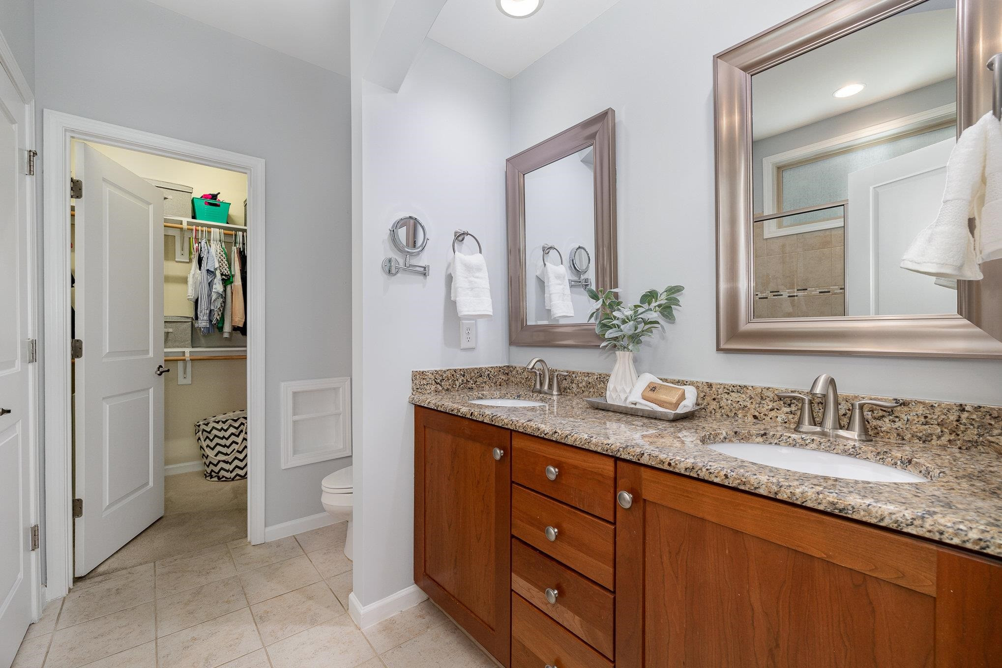 5522 Wade Park Boulevard Raleigh, NC 27607 - Photo 8 of 17 a bathroom with a granite countertop sink and a mirror