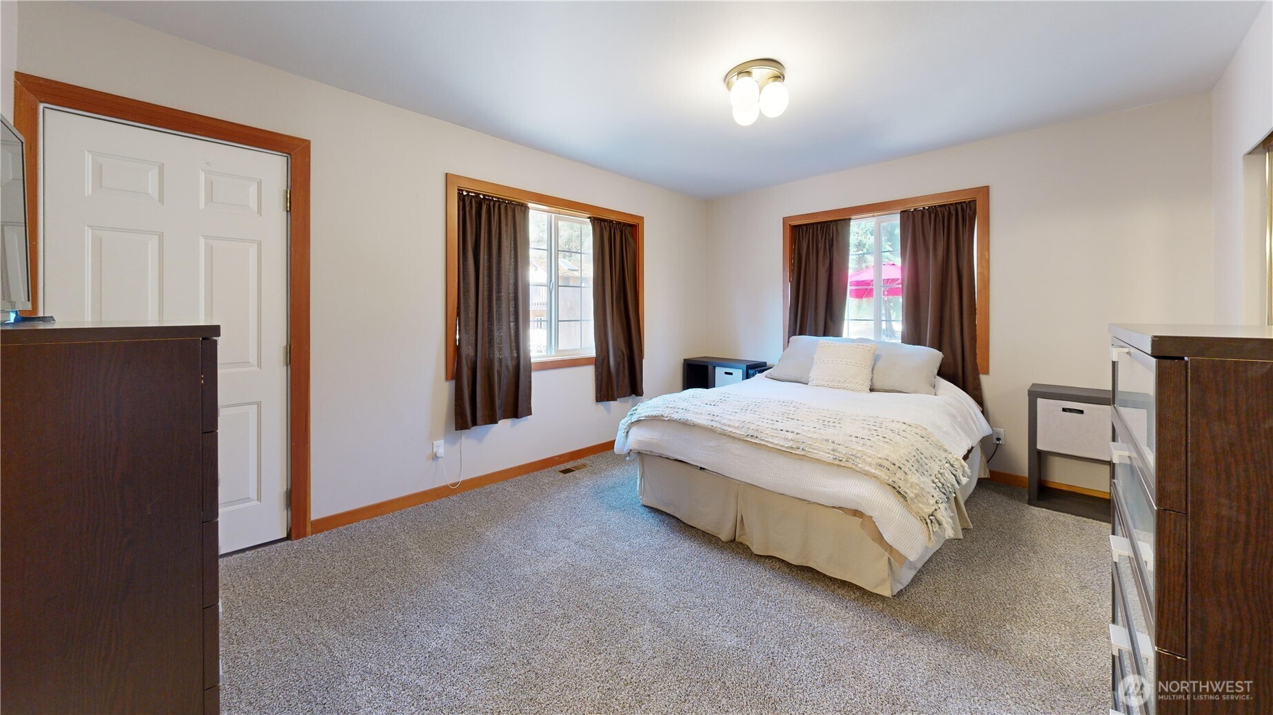 35812 Allen Road South Roy, WA 98580 - Photo 12 of 39 a bedroom with a large bed and a chandelier