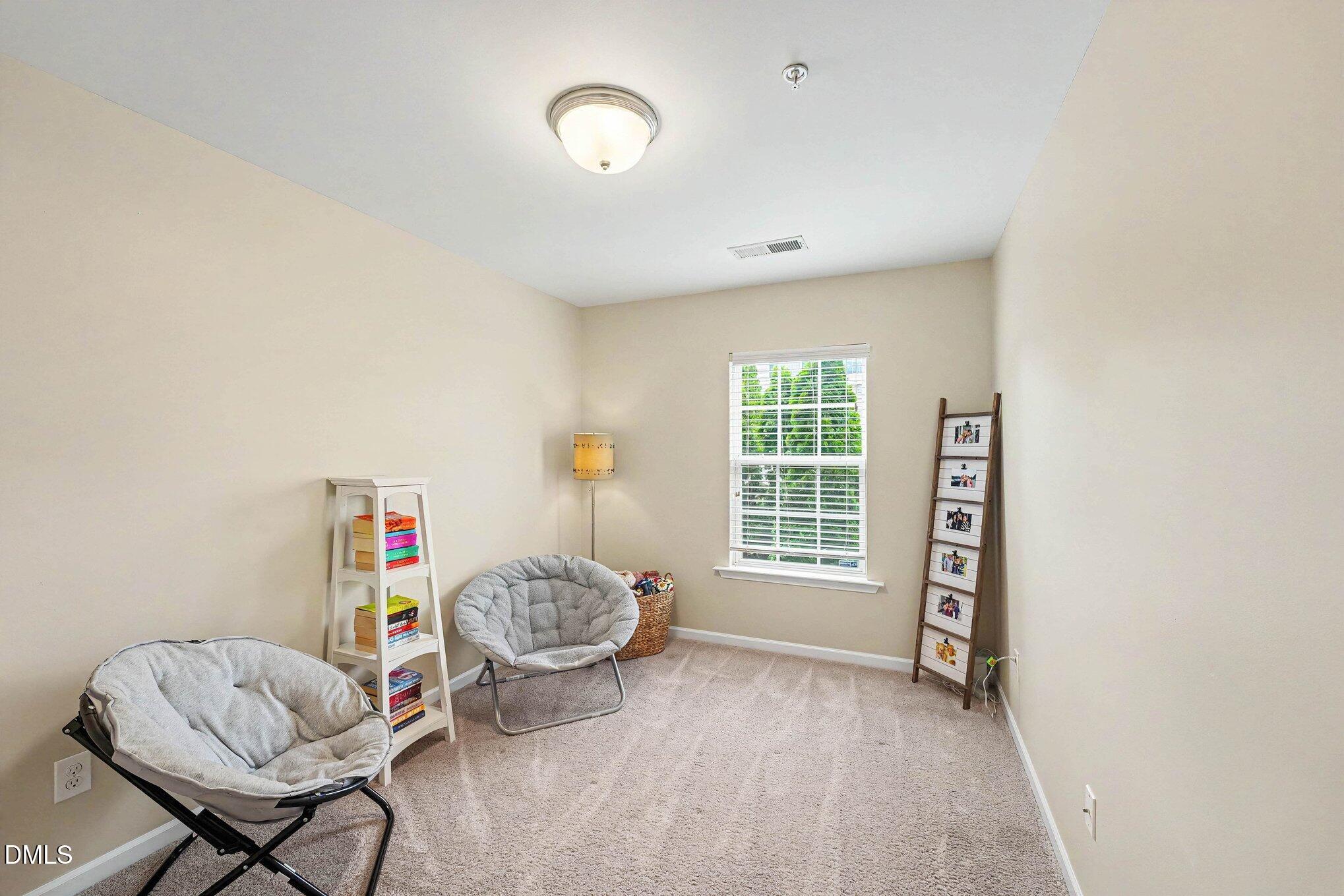 1130 Renewal Place, Unit 106 Raleigh, NC 27603 - Photo 22 of 34 a living room with furniture and a window