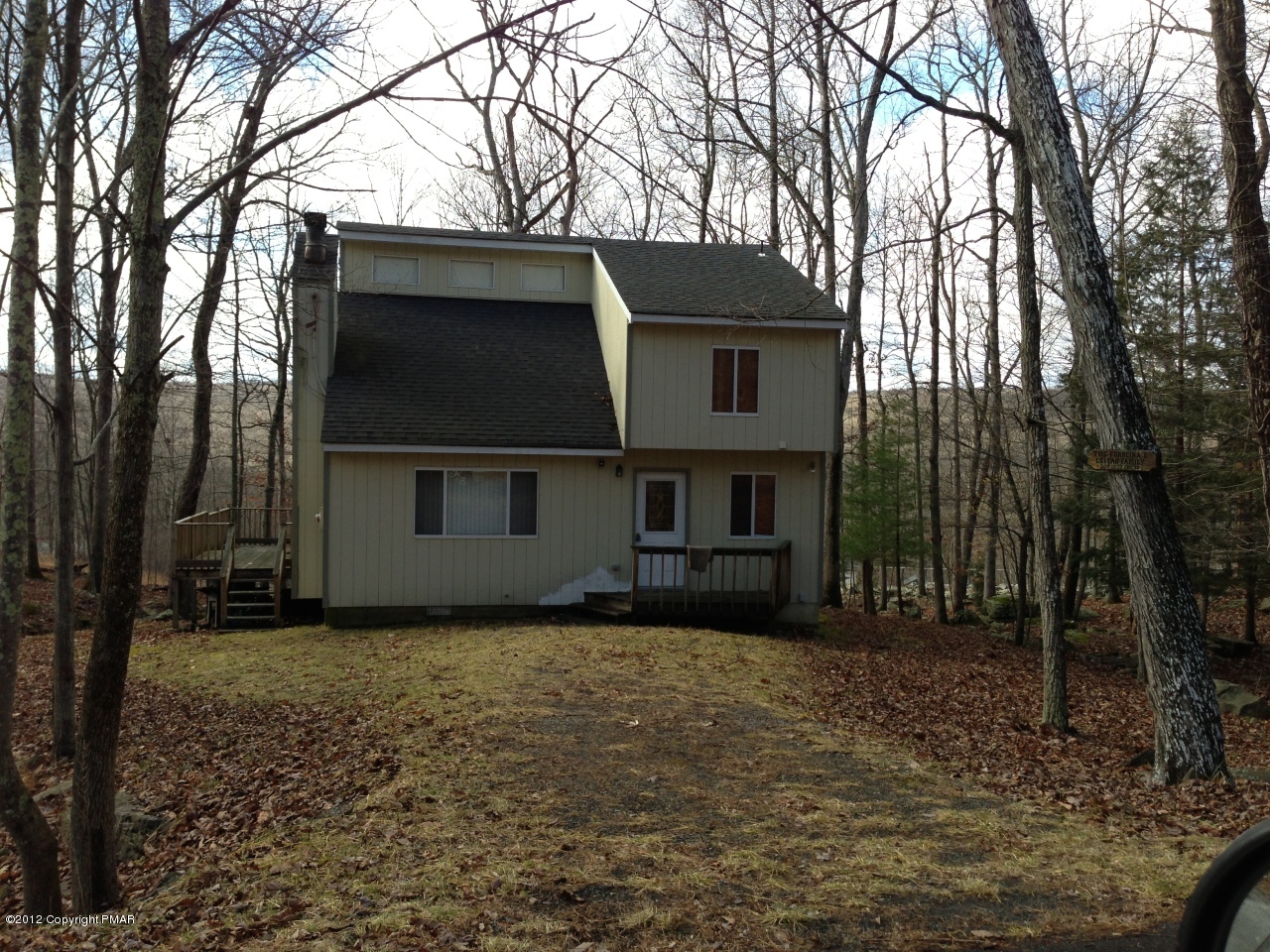 1237 Salisbury Road Bushkill, PA 18324 - Photo 1 of 11 a view of a house with a large tree and a yard