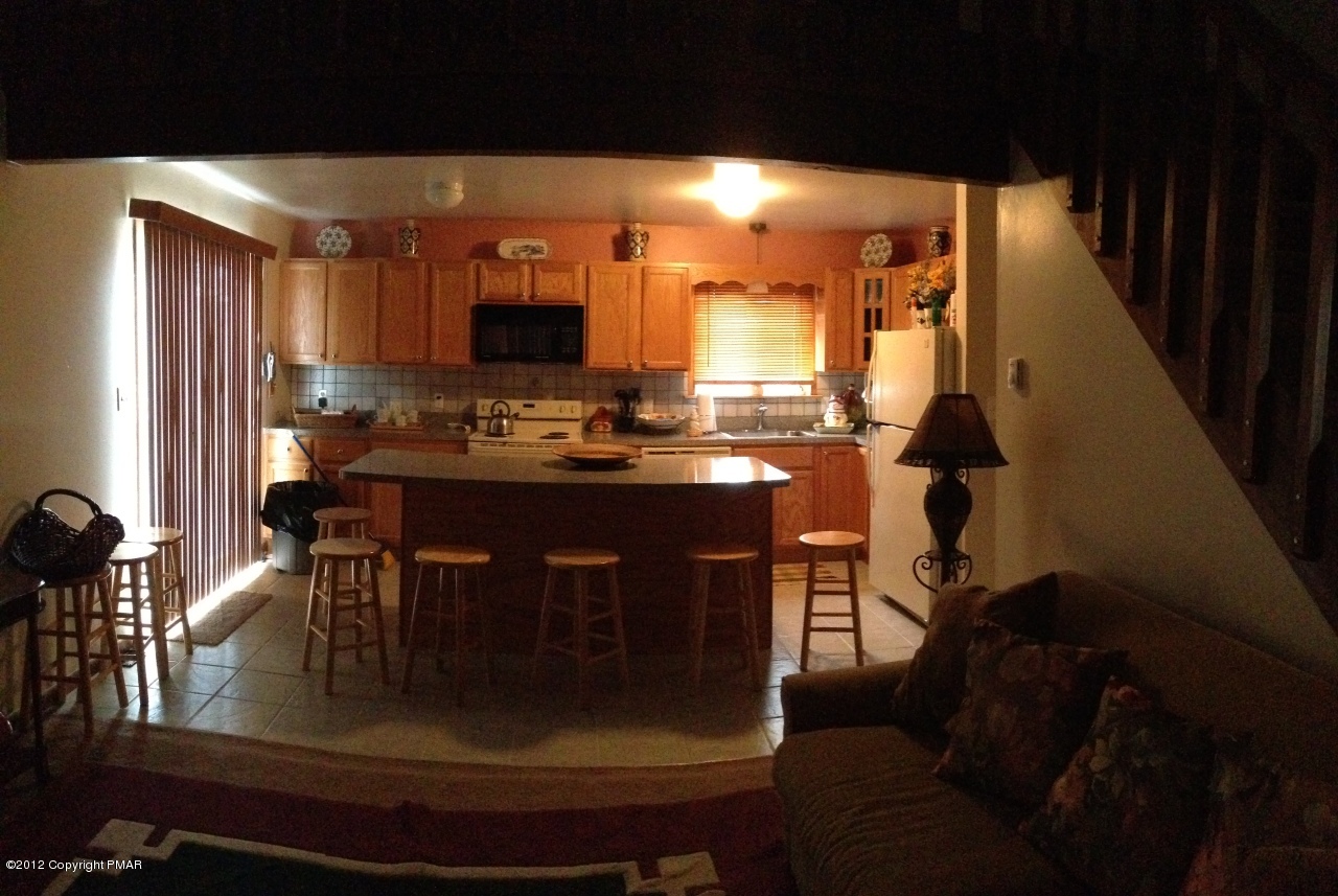 1237 Salisbury Road Bushkill, PA 18324 - Photo 4 of 11 a kitchen with a table chairs sink and cabinets