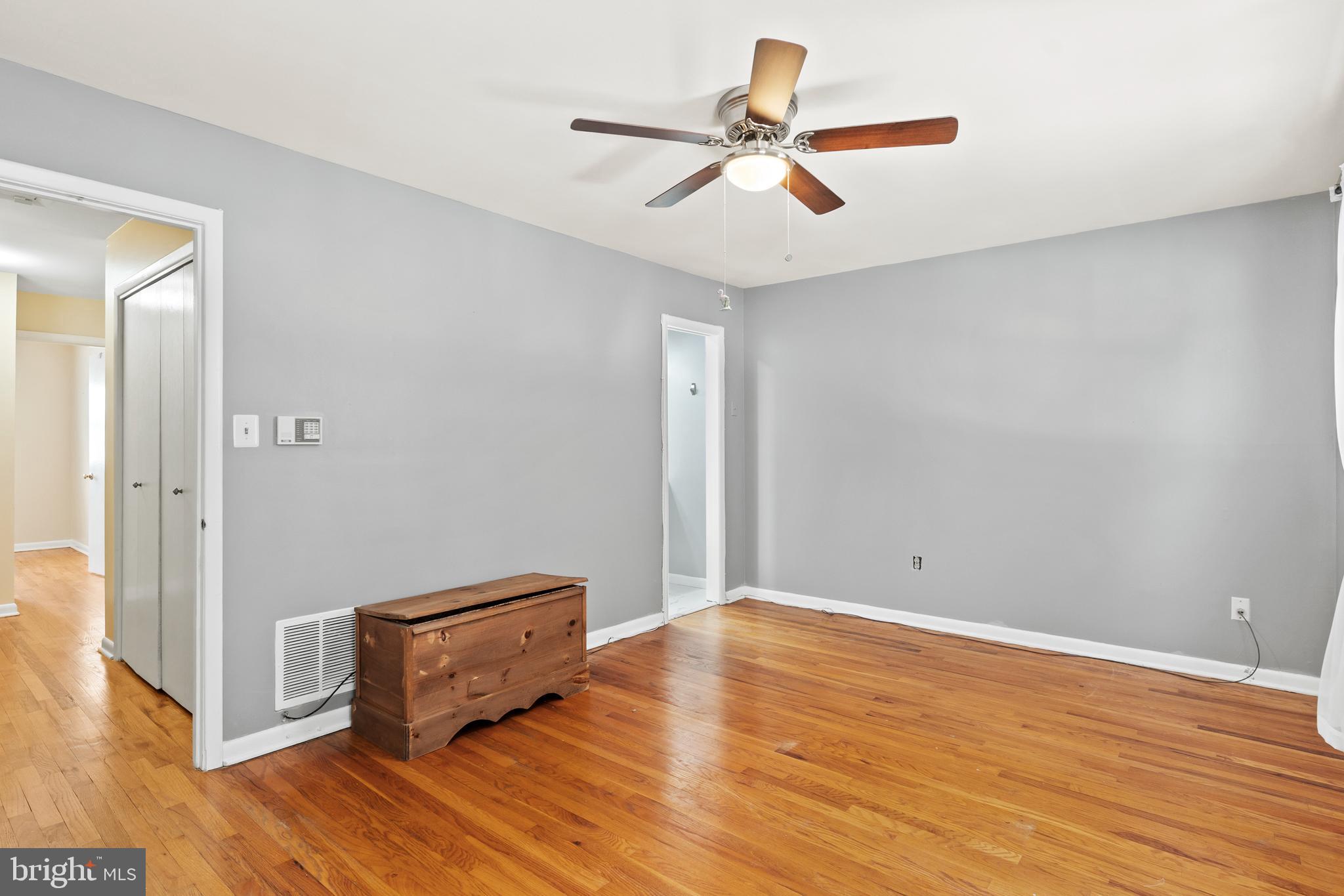 1204 Cedar Park Road, Unit 6 Annapolis, MD 21401 - Photo 19 of 51 an empty room with wooden floor and a ceiling fan