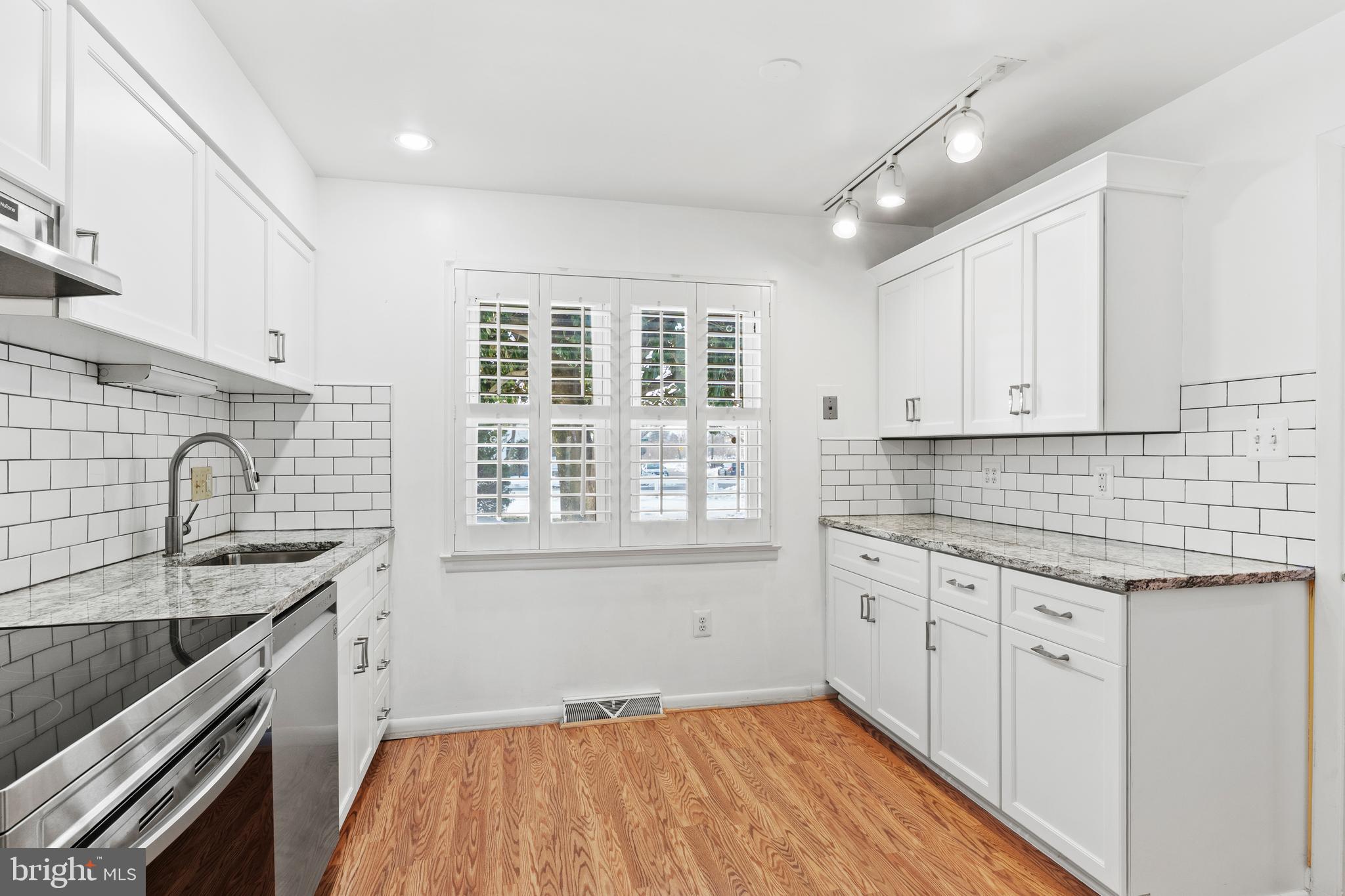 1204 Cedar Park Road, Unit 6 Annapolis, MD 21401 - Photo 7 of 51 a kitchen with granite countertop a sink stove and cabinets