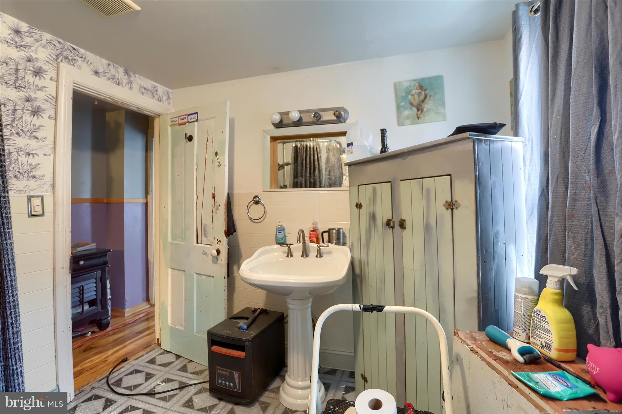 1433 3rd Street Enola, PA 17025 - Photo 17 of 29 a bathroom with a sink mirror and a window