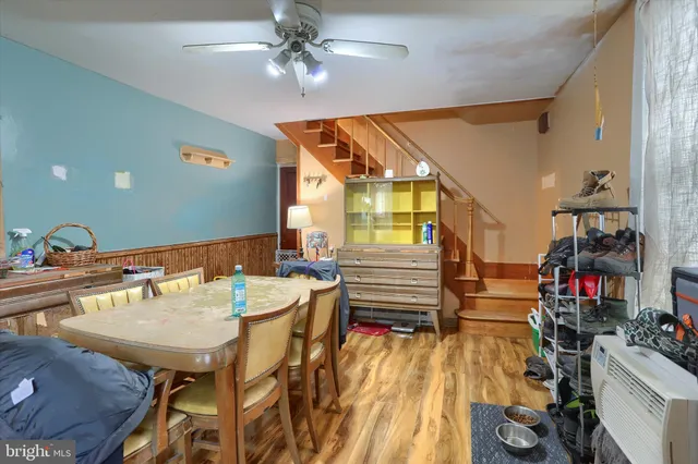 a view of a dining room with furniture and a chandelier fan