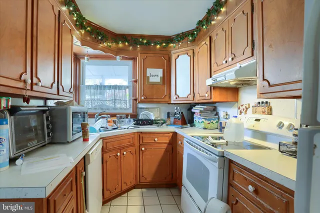 a kitchen with stainless steel appliances granite countertop a sink a stove and cabinets