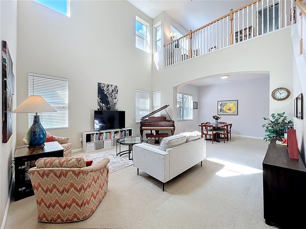 6573 Helmsley Circle Windermere, FL 34786 - Photo 12 of 54 a living room with furniture and a lamp