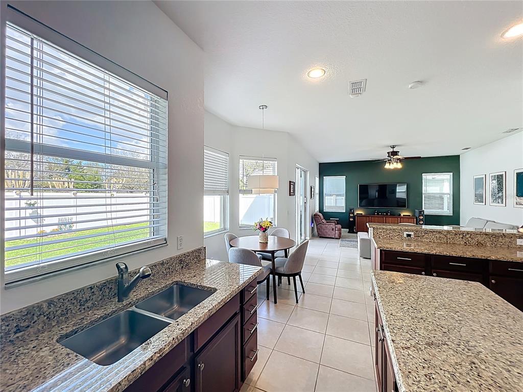 6573 Helmsley Circle Windermere, FL 34786 - Photo 17 of 54 a kitchen with counter top space sink stove and oven