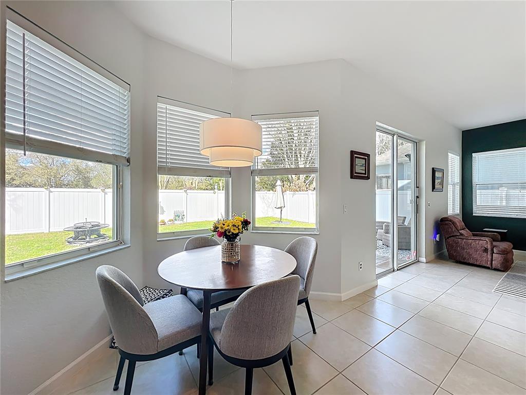 6573 Helmsley Circle Windermere, FL 34786 - Photo 19 of 54 a view of a dining room with furniture and a large window