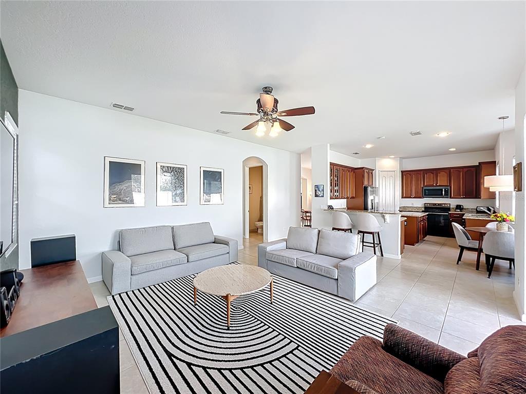 6573 Helmsley Circle Windermere, FL 34786 - Photo 20 of 54 a living room with furniture a rug and a chandelier