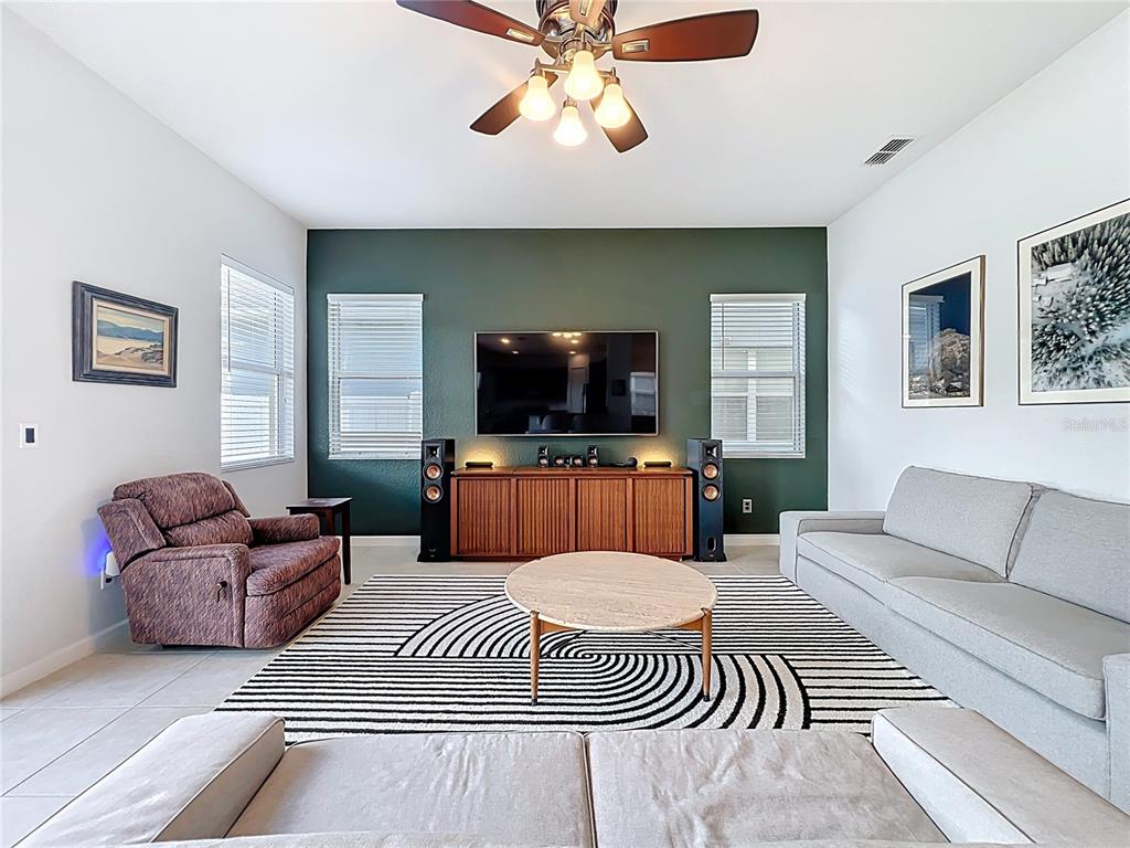 6573 Helmsley Circle Windermere, FL 34786 - Photo 22 of 54 a living room with furniture and a flat screen tv