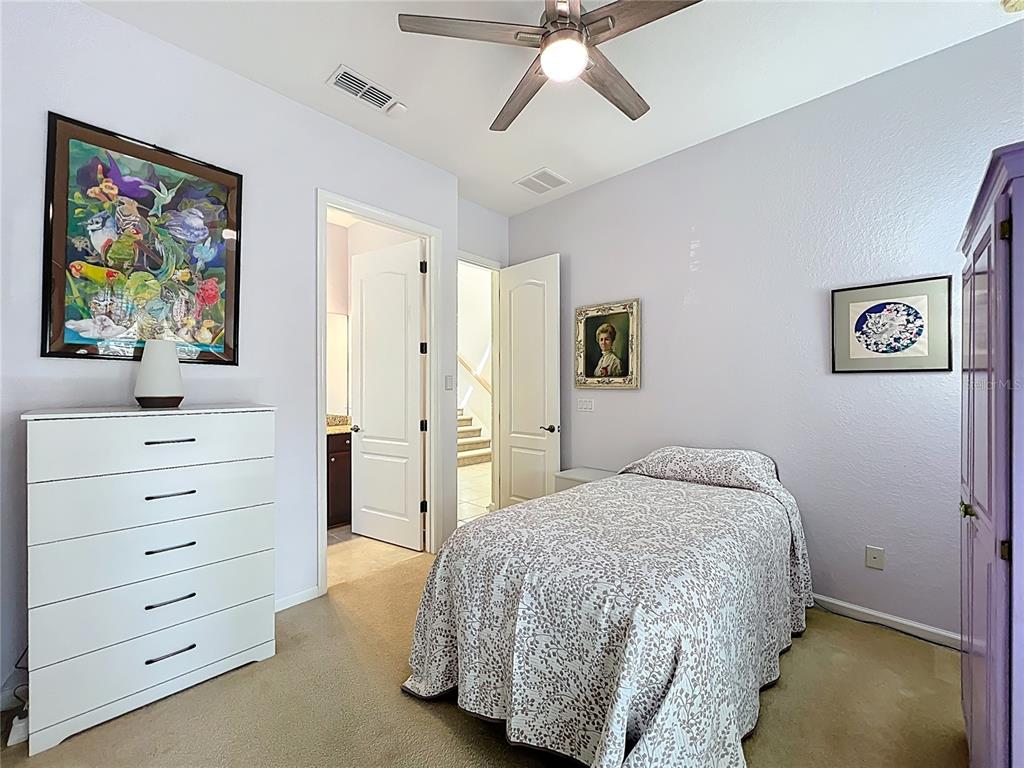 6573 Helmsley Circle Windermere, FL 34786 - Photo 26 of 54 a bedroom with a bed and a painting on the wall