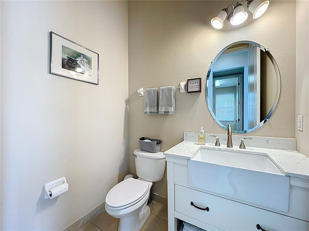 6573 Helmsley Circle Windermere, FL 34786 - Photo 28 of 54 a bathroom with a toilet a sink and mirror