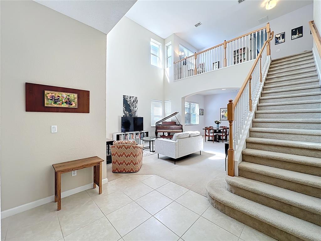 6573 Helmsley Circle Windermere, FL 34786 - Photo 29 of 54 a living room with furniture and stairs