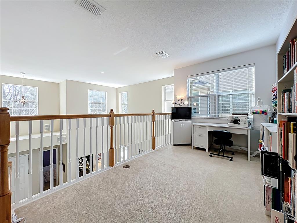 6573 Helmsley Circle Windermere, FL 34786 - Photo 31 of 54 a living room with furniture and a fireplace