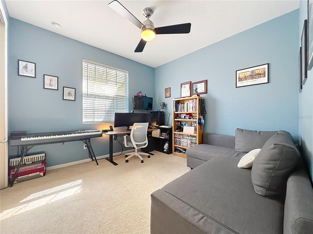 6573 Helmsley Circle Windermere, FL 34786 - Photo 48 of 54 a living room with furniture gym equipment and a window