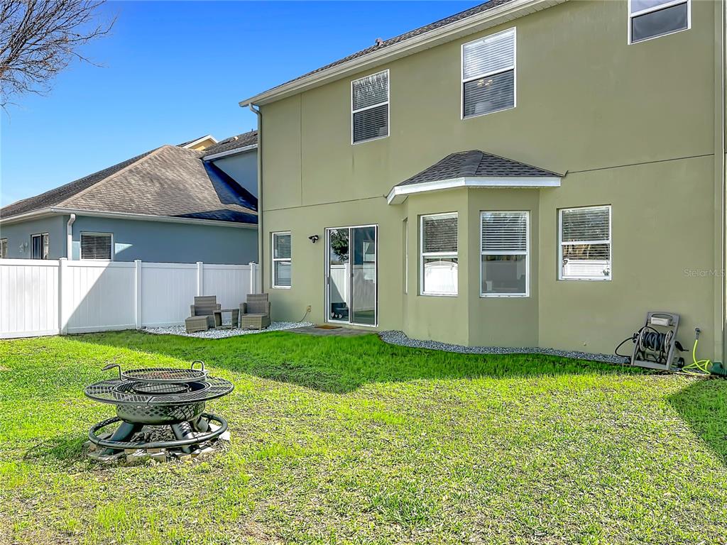 6573 Helmsley Circle Windermere, FL 34786 - Photo 50 of 54 a backyard of a house with table and chairs