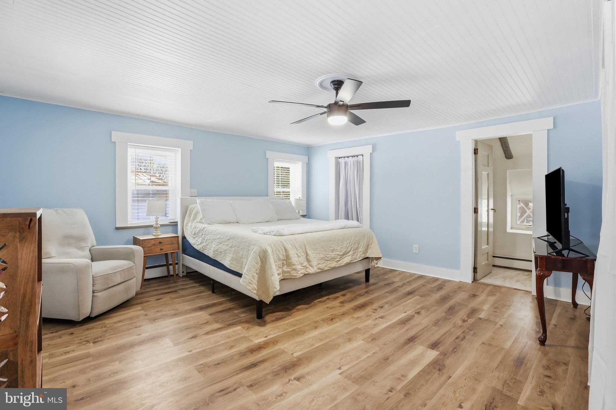 15539 Liberty Road Mount Airy, MD 21771 - Photo 22 of 68 a bedroom with a bed a couch and a flat screen tv