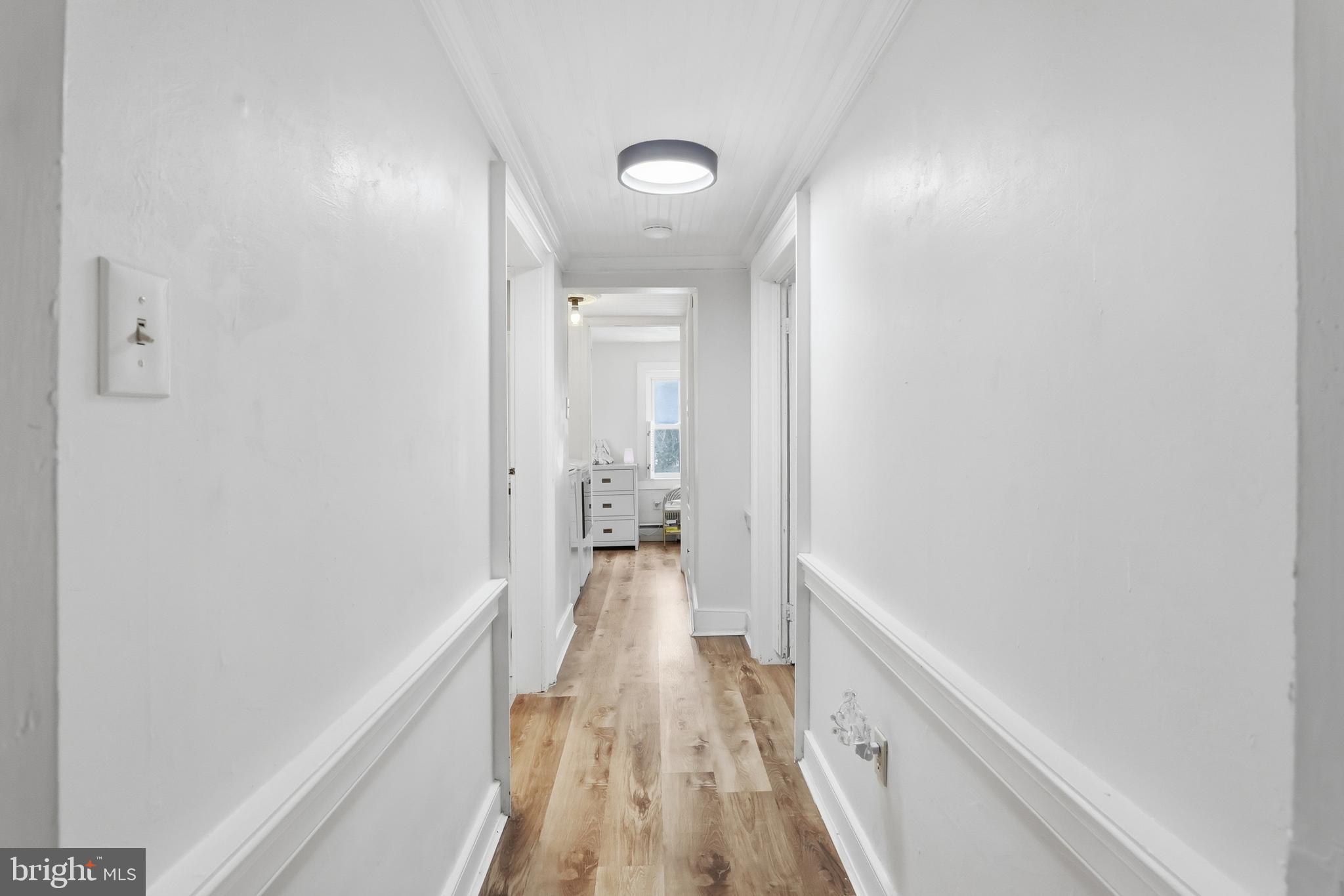 15539 Liberty Road Mount Airy, MD 21771 - Photo 28 of 68 a view of a hallway with wooden floor and a bathroom