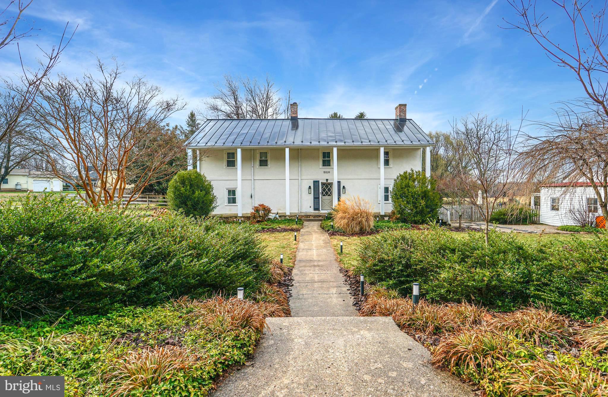 15539 Liberty Road Mount Airy, MD 21771 - Photo 40 of 68 a front view of a house with a yard and potted plants