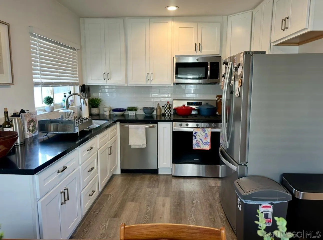 526 4th Street Encinitas, CA 92024 - Photo 1 of 10 a kitchen with stainless steel appliances granite countertop a sink a stove a refrigerator cabinets and a window