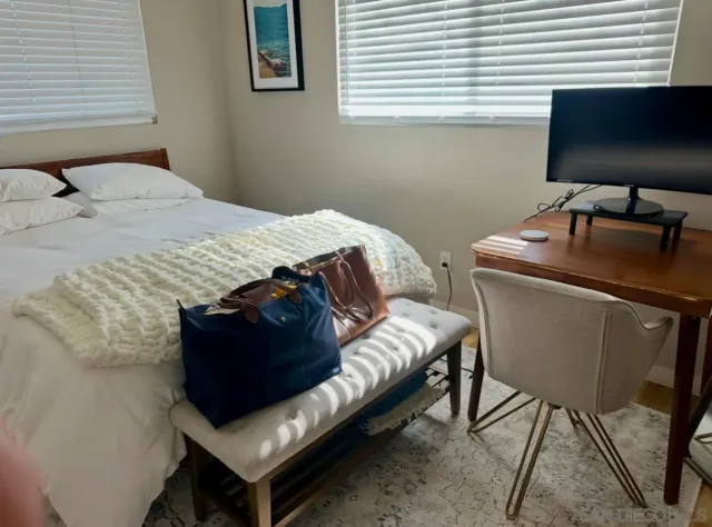 a bedroom with a bed and a flat screen tv