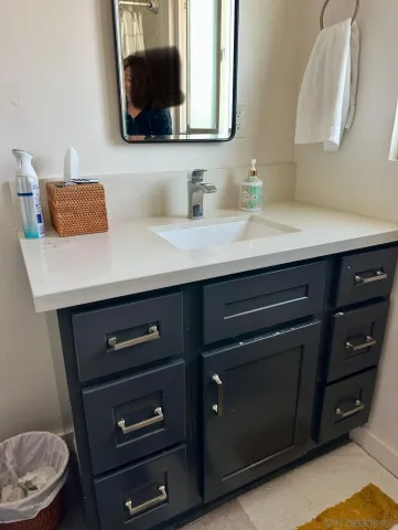 a bathroom with a sink a light fixture and a toilet