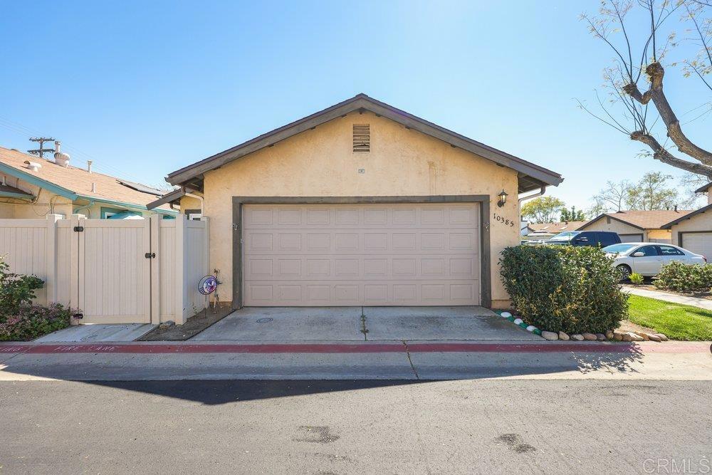 10385 Seth Way Santee, CA 92071 - Photo 5 of 33 a front view of a house with a yard and garage