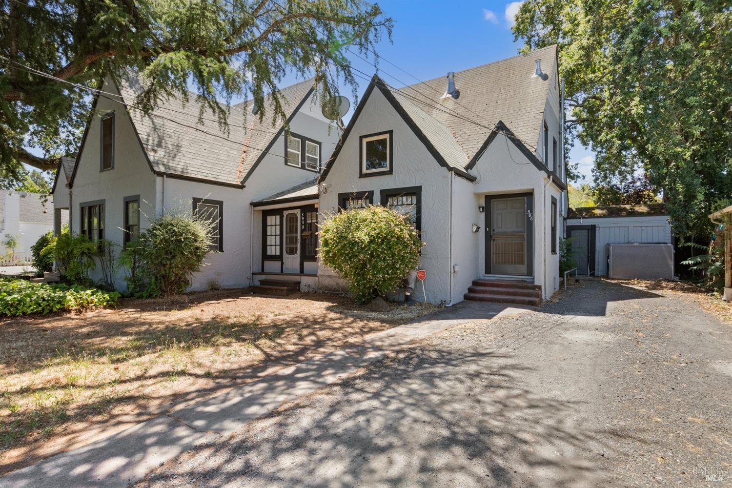 a view of a house with a tree in front