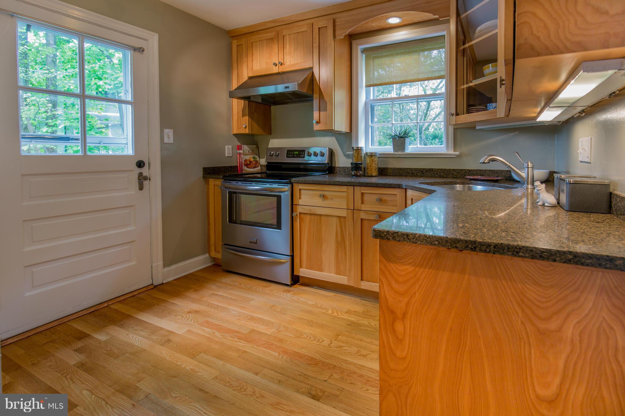 310 Brewster Court Silver Spring, MD 20901 - Photo 12 of 30 a kitchen with granite countertop a sink window and cabinets