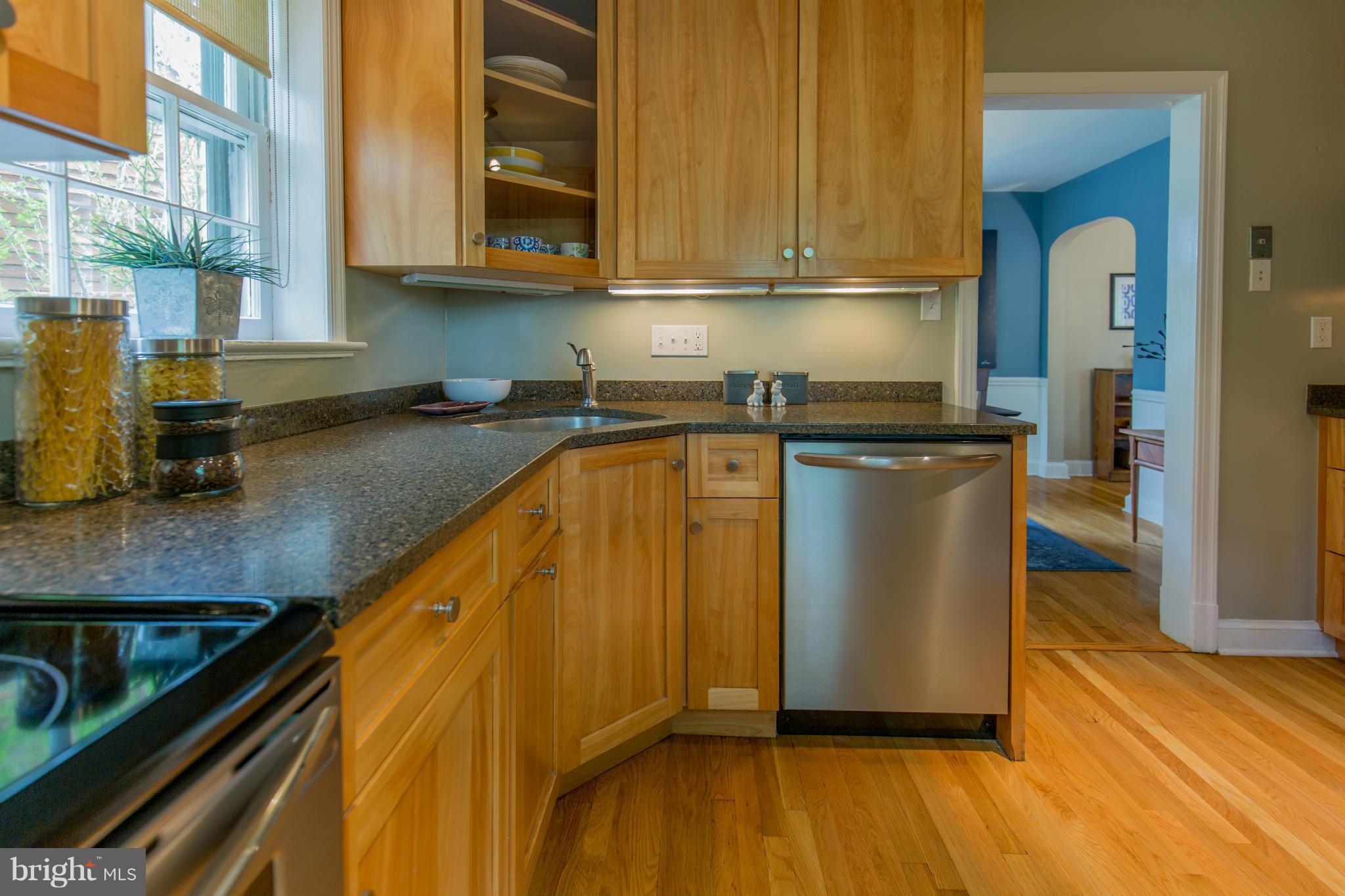 310 Brewster Court Silver Spring, MD 20901 - Photo 14 of 30 a kitchen with granite countertop wooden cabinets a sink and dishwasher