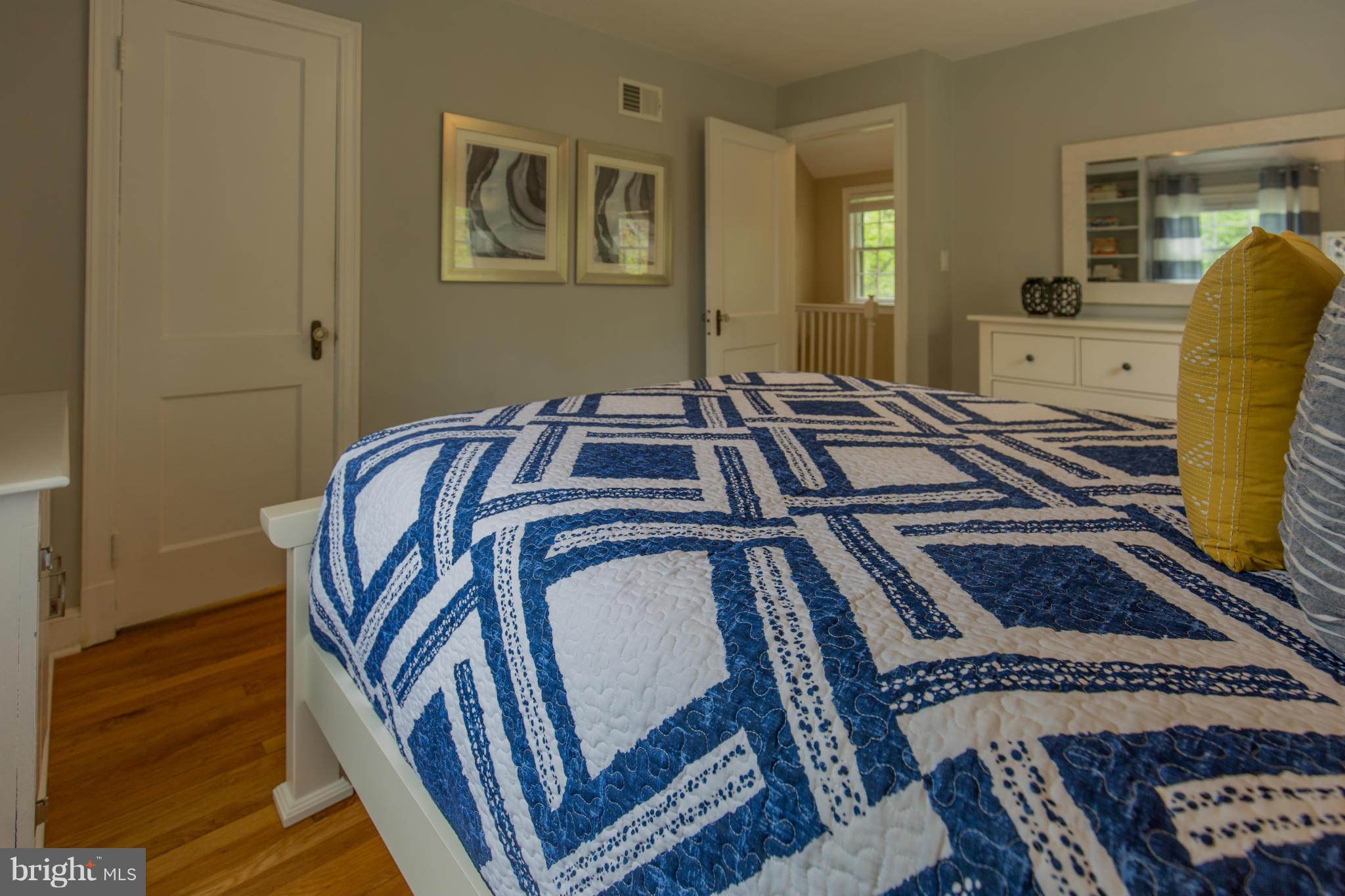 310 Brewster Court Silver Spring, MD 20901 - Photo 17 of 30 a bedroom with a bed and wooden floor