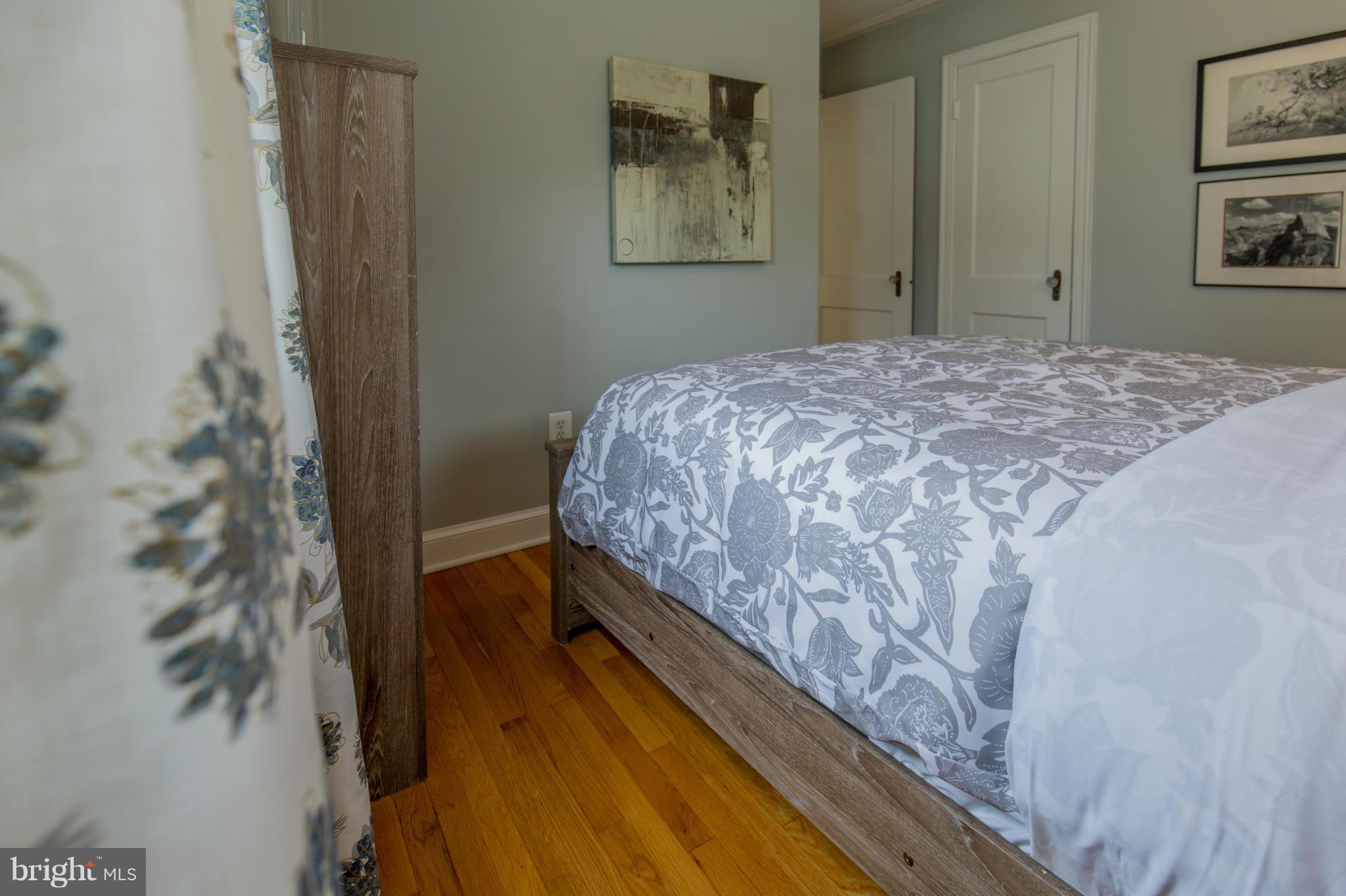 310 Brewster Court Silver Spring, MD 20901 - Photo 20 of 30 a bedroom with a bed and a painting on the wall