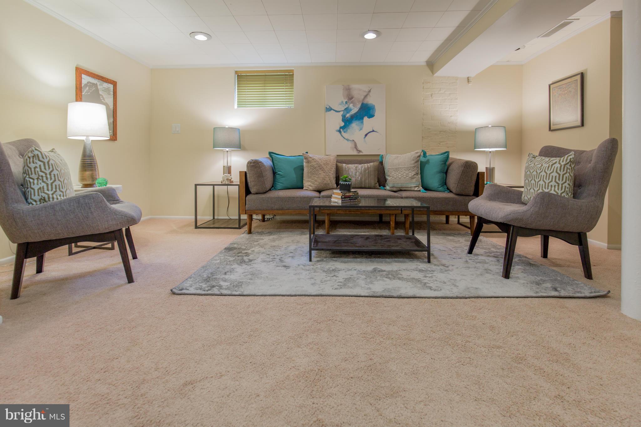 310 Brewster Court Silver Spring, MD 20901 - Photo 27 of 30 a living room with furniture and a lamp