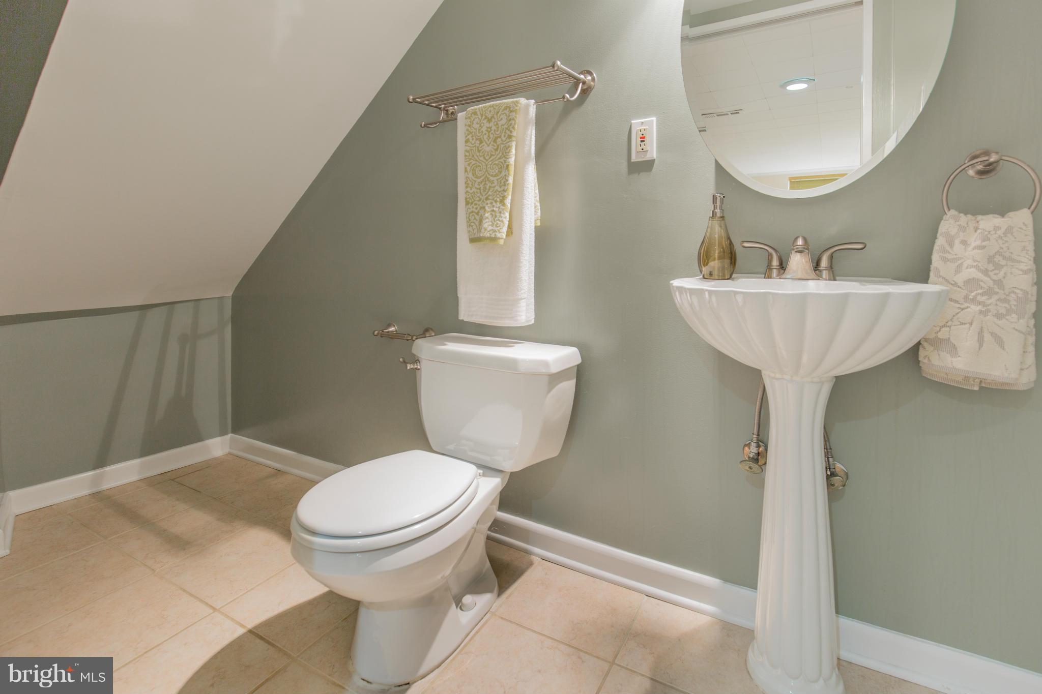 310 Brewster Court Silver Spring, MD 20901 - Photo 29 of 30 a bathroom with a toilet sink and mirror