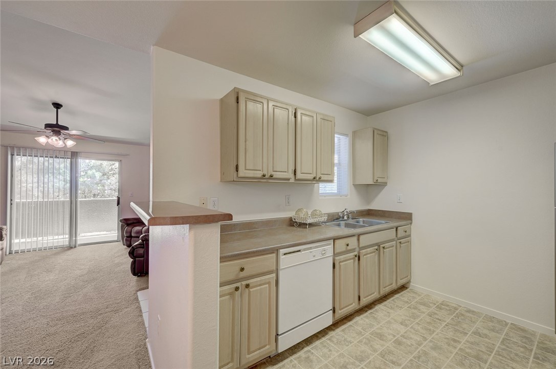 555 East Silverado Ranch Boulevard, Unit 2124 Las Vegas, NV 89183 - Photo 15 of 47 Functional kitchen with ample cabinet space, seamlessly connecting to the living area.