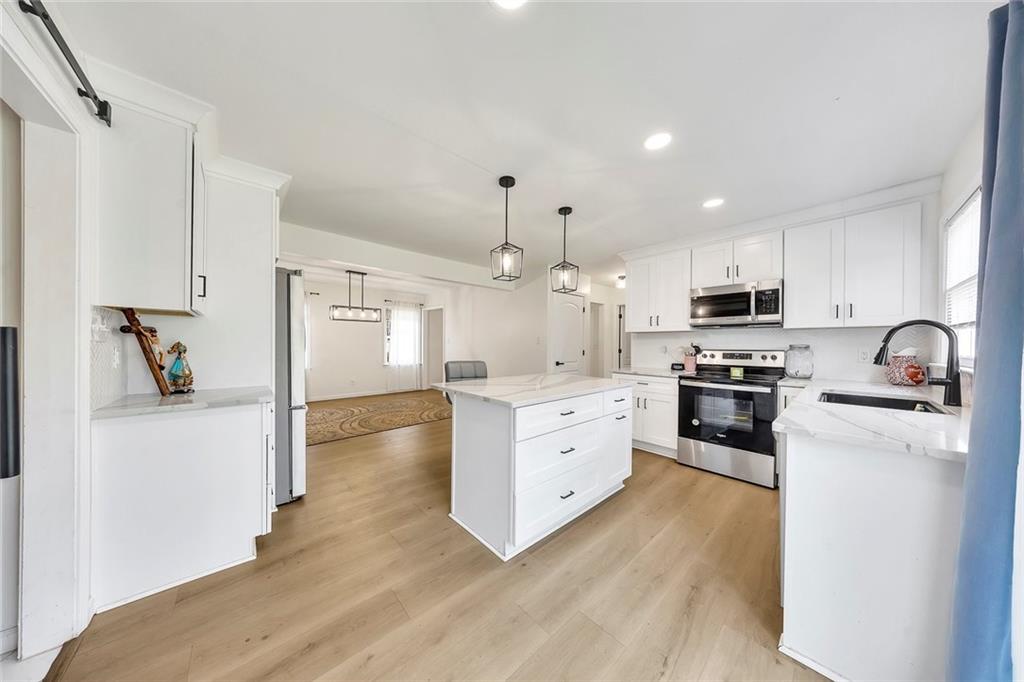 2328 Carnes Road Jonesboro, GA 30236 - Photo 13 of 36 a kitchen with granite countertop a refrigerator stove top oven and sink