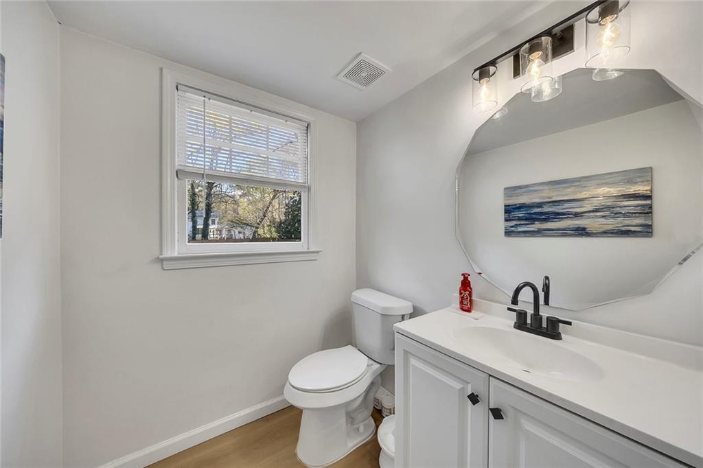 2328 Carnes Road Jonesboro, GA 30236 - Photo 17 of 36 a bathroom with a sink a toilet and a mirror