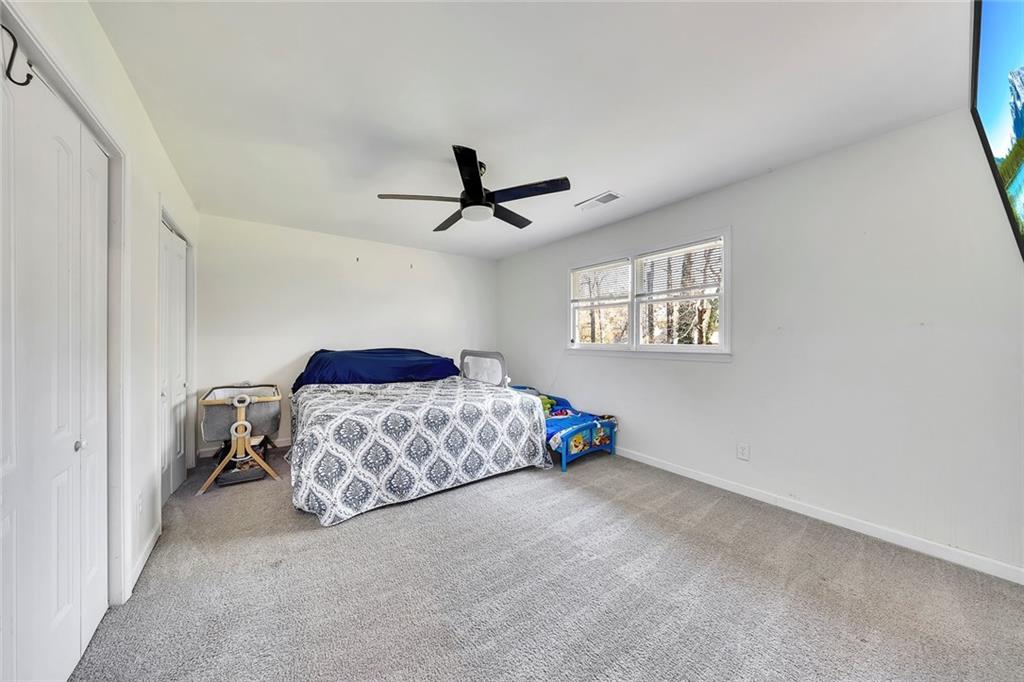 2328 Carnes Road Jonesboro, GA 30236 - Photo 20 of 36 a bedroom with a bed and a ceiling fan