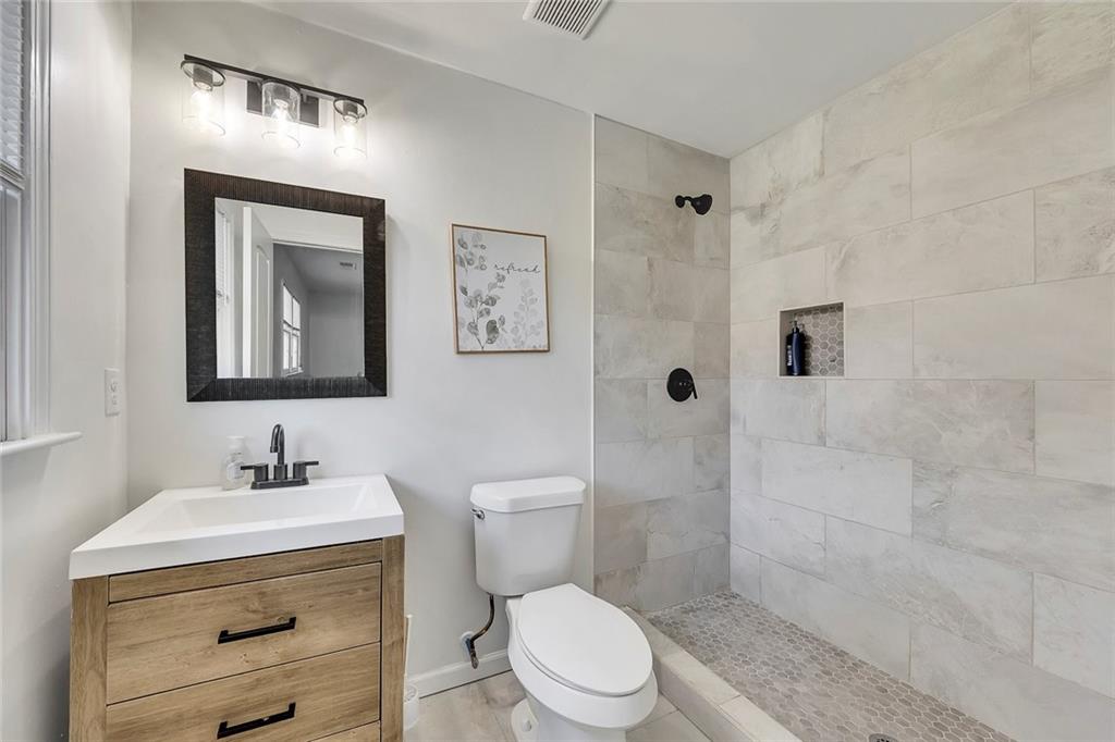 2328 Carnes Road Jonesboro, GA 30236 - Photo 22 of 36 a bathroom with a toilet sink and shower